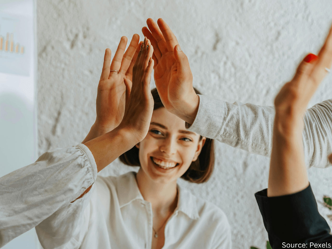 people smiling and high fiving